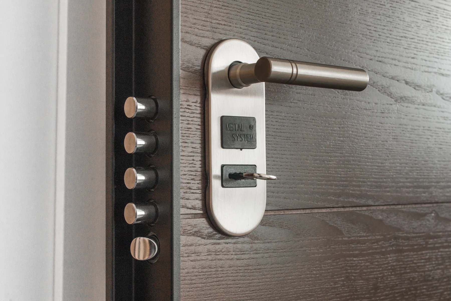 Close-up of a modern deadbolt and door handle with a key inserted